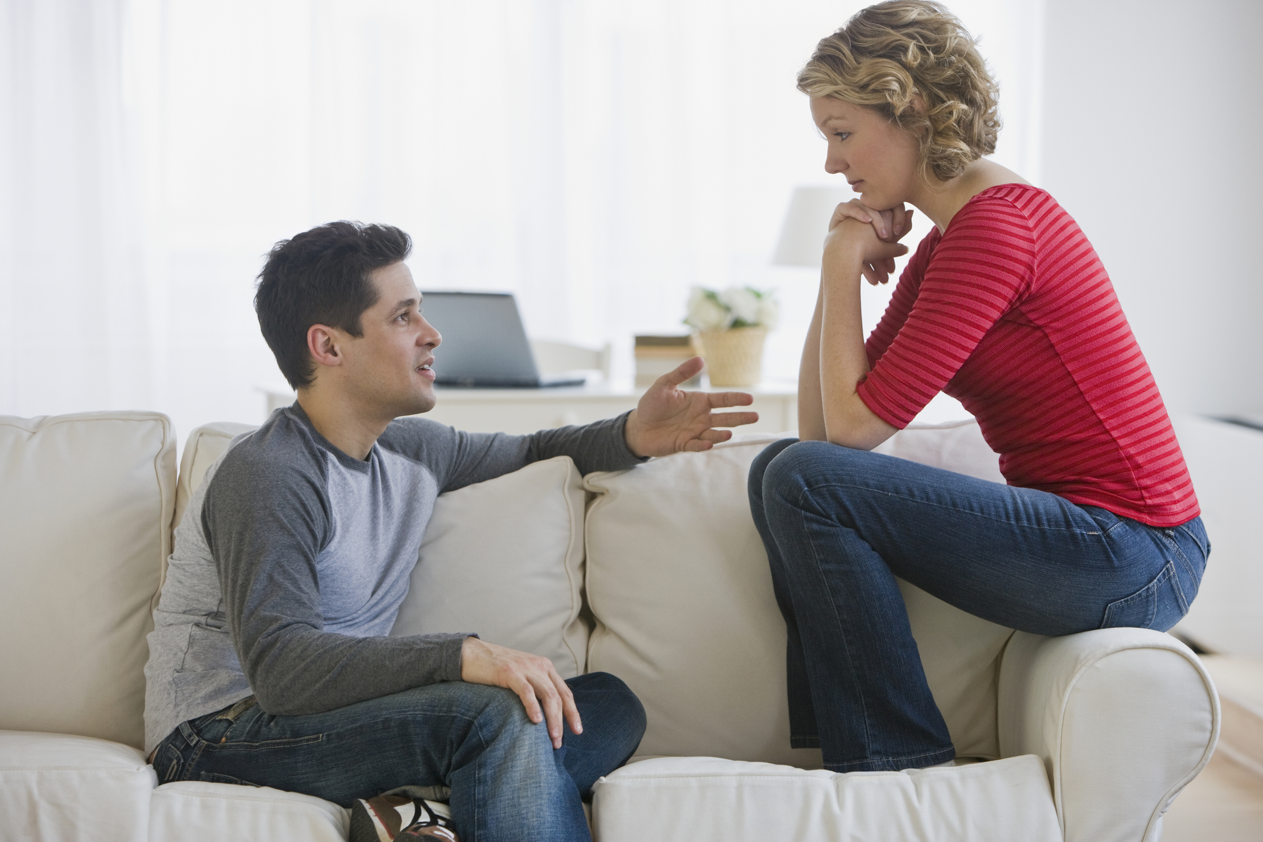 Couple talking on sofa